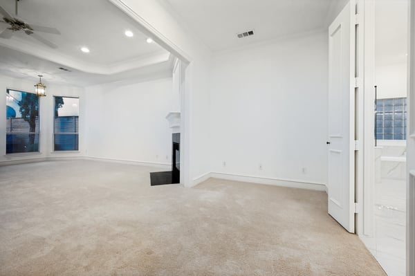 Bright and spacious living area with large windows, offering ample natural light and versatile layout options.