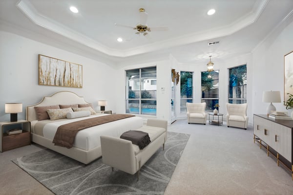 Spacious master bedroom boasts ample natural light with direct access to a private outdoor area.