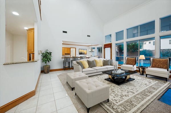 Spacious living area features high ceilings, large windows, and a welcoming layout perfect for entertaining.
