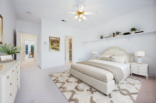 Spacious bedroom featuring natural light, a cozy layout, and seamless access to adjoining rooms.