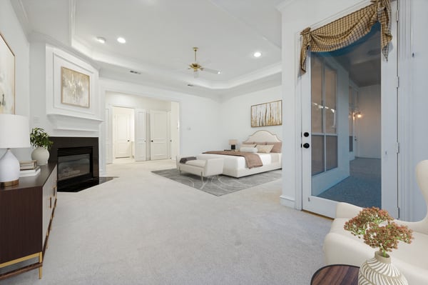 Spacious primary bedroom featuring a cozy fireplace and seamless access to a private sitting area.