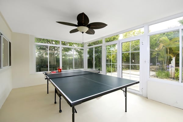 Enclosed sunroom next to backyard.