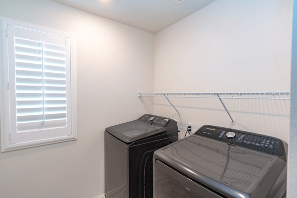 Bright laundry room featuring modern appliances and ample space for organization and utility.