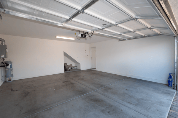 Spacious garage featuring clean, open space ideal for storage or vehicle parking, with direct access to the home.