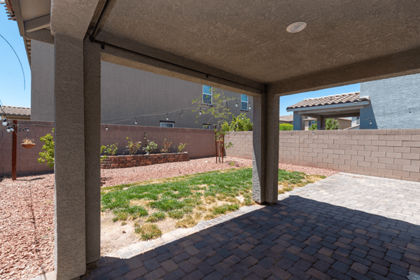 Spacious outdoor area features a covered patio, perfect for entertaining or relaxing in privacy.