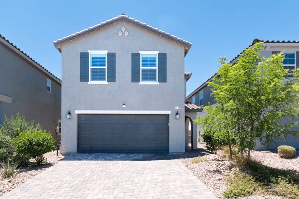 Modern home with a spacious driveway and attractive landscaping, conveniently located in a desirable neighborhood.