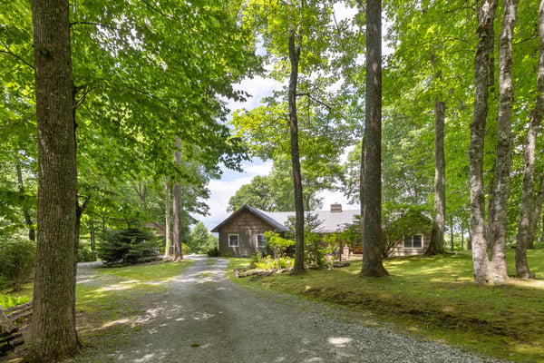 Nestled among lush trees, this spacious home offers a peaceful retreat with abundant outdoor space.