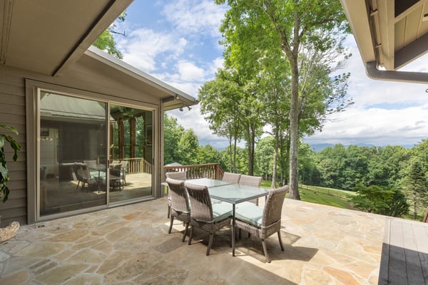 Spacious outdoor dining area with panoramic views, perfect for entertaining and enjoying nature's beauty.