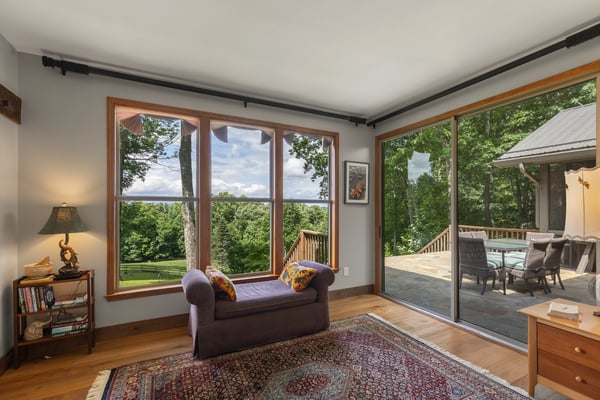 Bright, airy living space features expansive windows offering stunning views and seamless outdoor access.