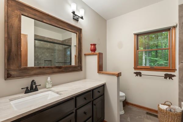 This inviting bathroom features a modern design with natural light and ample storage options.
