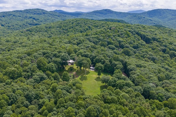 Secluded property on expansive wooded land, offering breathtaking mountain views and abundant outdoor space.