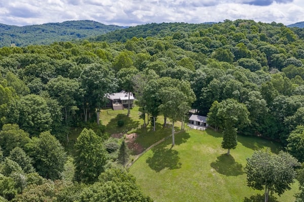 Discover a peaceful retreat surrounded by lush greenery and stunning mountain views, perfect for relaxing living.