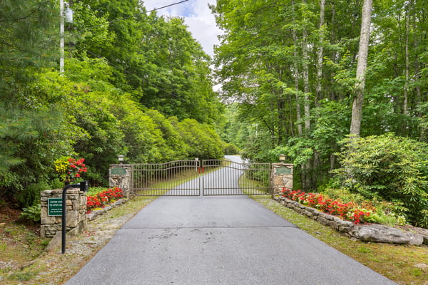 Private gated entrance leads to a lush, wooded retreat, perfect for your dream home or getaway.