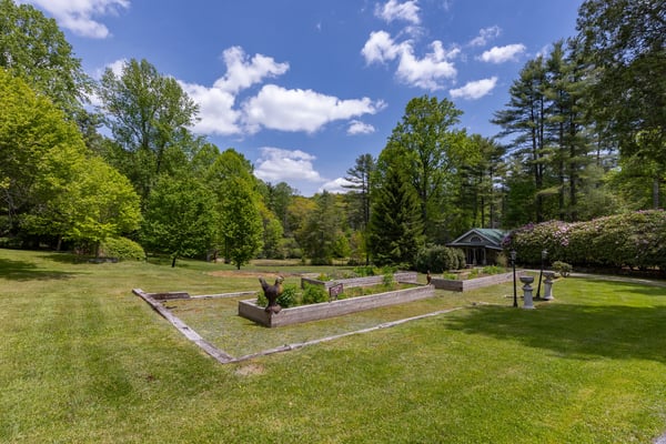 Expansive outdoor space featuring lush greenery and a tranquil garden area, perfect for relaxation and gatherings.