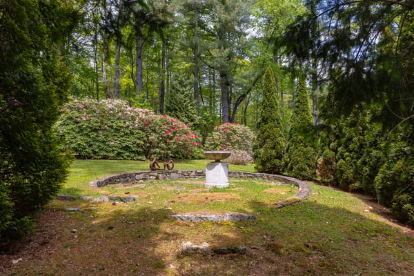 Discover a private backyard oasis surrounded by lush greenery and vibrant floral displays, perfect for relaxation.