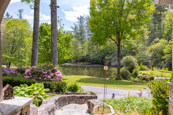 Breathtaking views of a tranquil pond surrounded by lush greenery, perfect for outdoor relaxation and enjoyment.