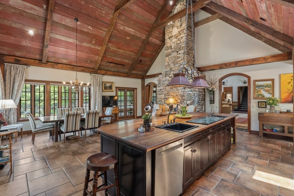 Experience this inviting kitchen, featuring a spacious island, rustic details, and ample natural light.