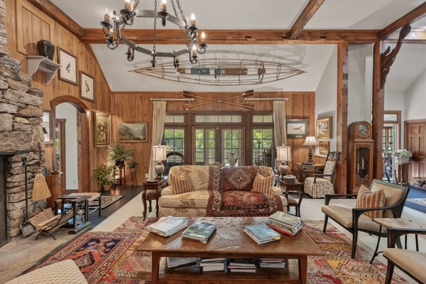 Spacious, inviting living area featuring a striking stone fireplace and artistic touches throughout.