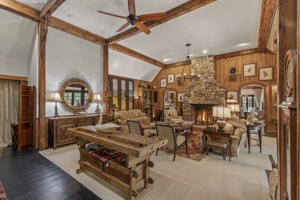 Spacious great room featuring a stunning stone fireplace and wood accents, perfect for entertaining and relaxation.