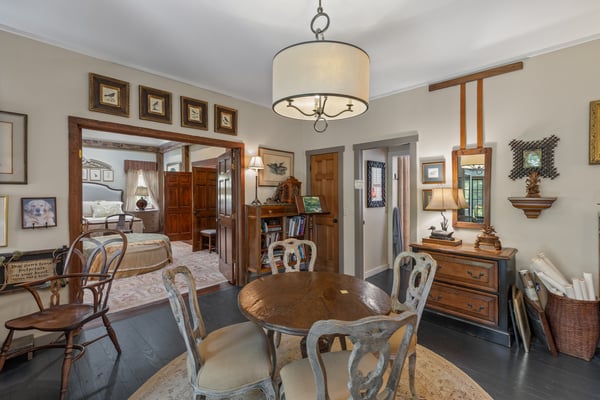 Cozy dining area featuring vintage decor, seamless flow to adjoining living space, and warm ambiance.