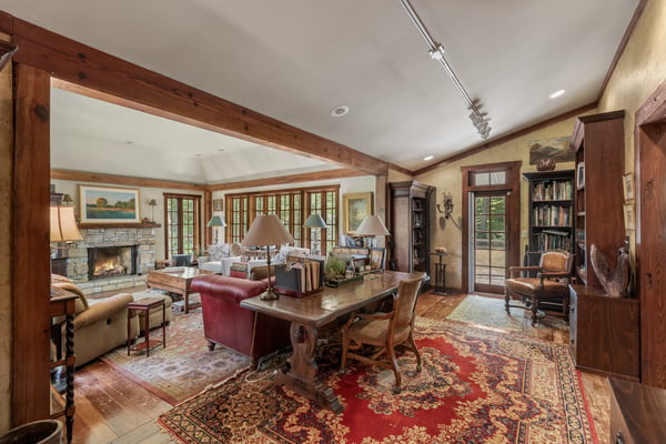 This inviting living space features warm wood accents, a cozy fireplace, and abundant natural light.
