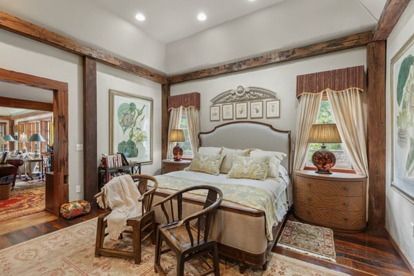 Cozy bedroom featuring natural light, warm wood accents, and unique artwork for a personal touch.