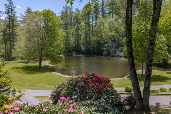 Discover this peaceful property with lush landscaping and a private pond, ideal for outdoor relaxation.