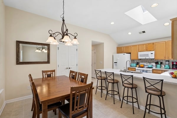 Open-concept kitchen and dining area (virtually staged)