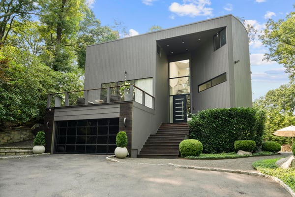 Contemporary home featuring open spaces and abundant natural light, surrounded by lush greenery and scenic views.