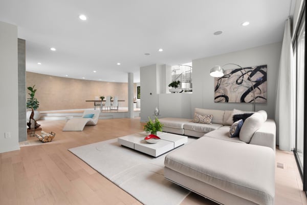 Spacious, contemporary living area featuring abundant natural light and modern design elements throughout.