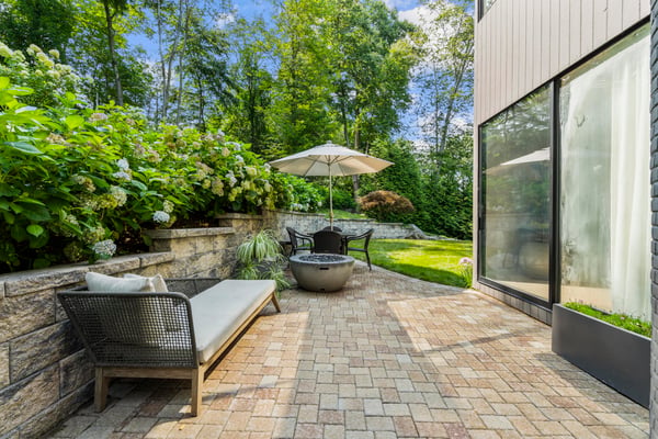 Discover a private outdoor oasis featuring a cozy seating area, mature landscaping, and a tranquil atmosphere.