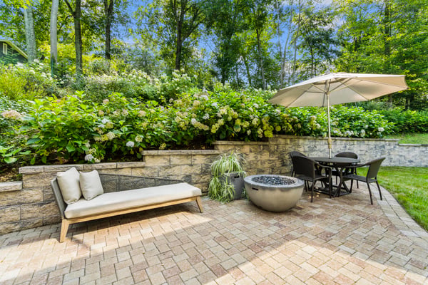 Discover a peaceful outdoor oasis featuring a cozy seating area and lush greenery for relaxation.