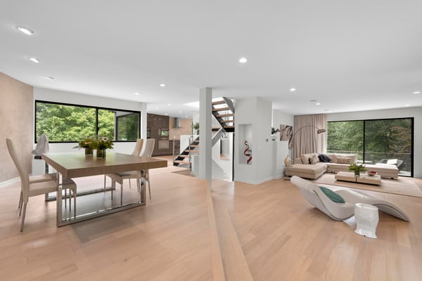 Bright and spacious open-concept living area with large windows and modern finishes, perfect for entertaining.
