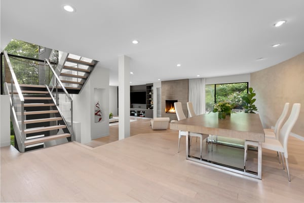 Spacious open floor plan features natural light, contemporary design, and a cozy fireplace for gatherings.