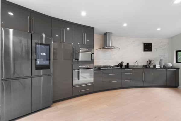 Modern kitchen featuring sleek cabinetry, high-end appliances, and a unique curved design for optimal functionality.