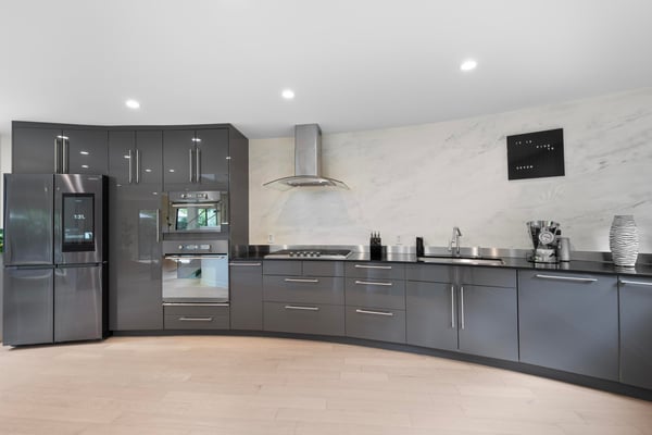 Modern kitchen with sleek cabinets, high-end appliances, and a unique curved design for optimal functionality.