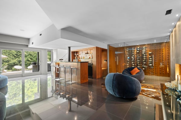Contemporary living space featuring a sleek kitchen, sophisticated wine storage, and expansive natural light.
