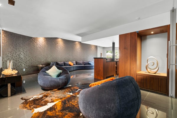Modern living space featuring unique seating, ambient lighting, and a striking decorative accent. Perfect for entertaining.