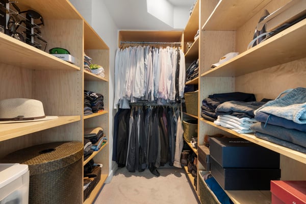 Spacious walk-in closet featuring ample shelving and organized sections for clothing and accessories.
