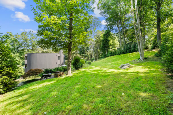 Expansive, wooded lot with gentle slopes, offering ample space for outdoor activities and future development.