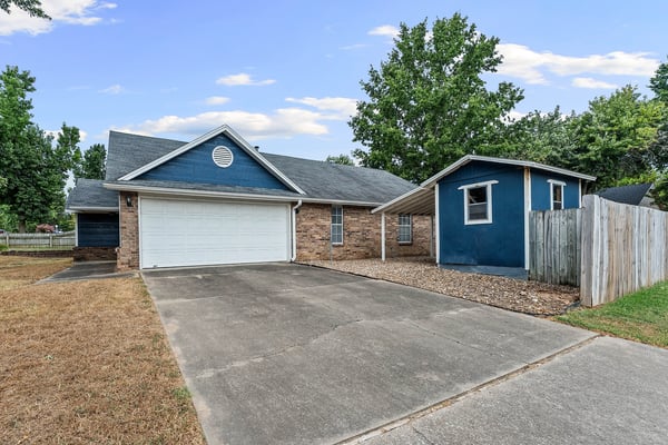 Two car garage on the side and one car carport attached to the shed