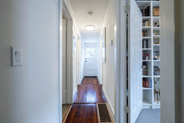 Bright and welcoming corridor featuring a mix of natural light and functional design elements.