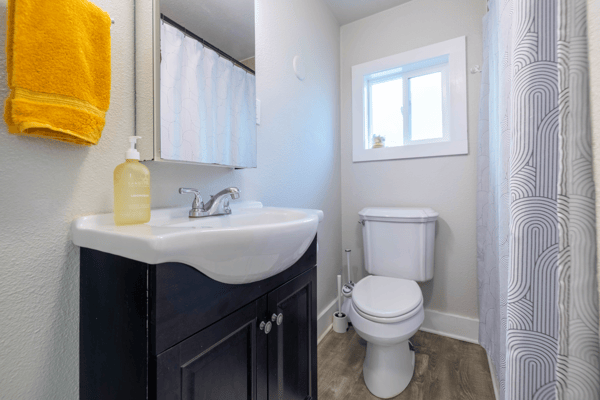 Modern bathroom featuring a sleek vanity, abundant natural light, and contemporary finishes for everyday convenience.