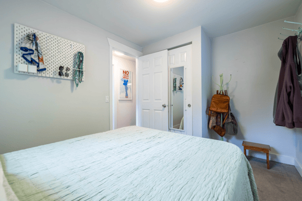 Cozy bedroom featuring a spacious layout, practical storage solutions, and convenient access to nearby amenities.