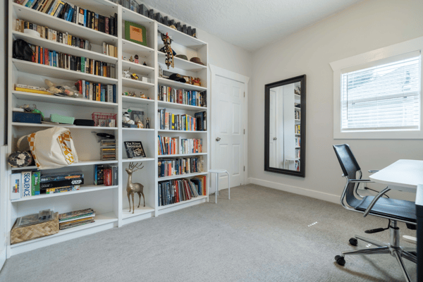 Bright study with built-in bookshelves, ample storage, and plenty of natural light for productivity.