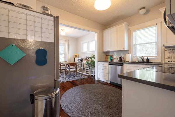 Bright kitchen featuring modern appliances, ample counter space, and an inviting dining area beyond.