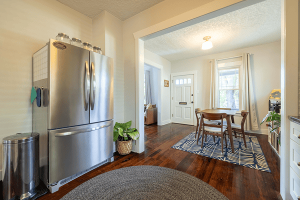 Bright and inviting kitchen flows seamlessly into a cozy dining area, ideal for gatherings and daily meals.