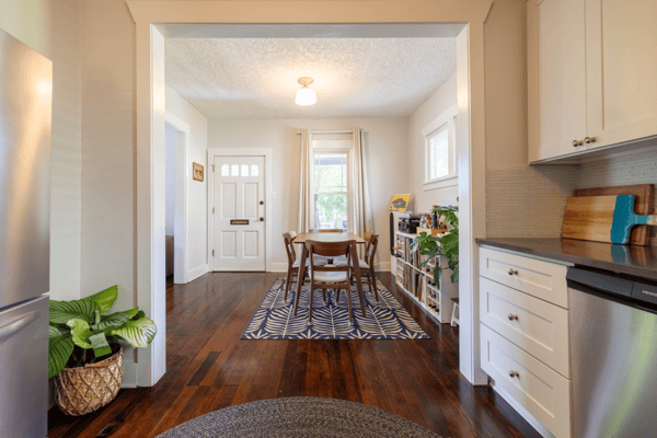 Bright and inviting open-concept space, featuring a modern kitchen leading to a cozy dining area.