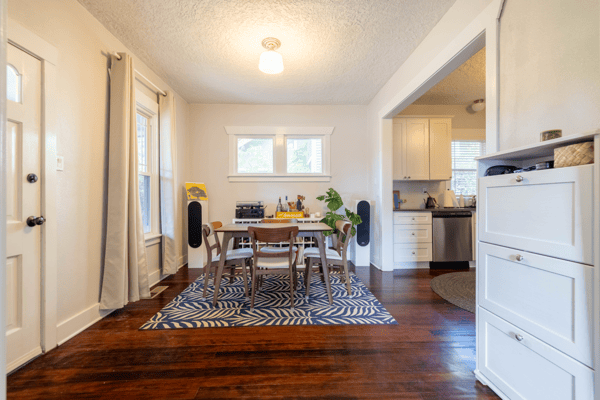Bright and inviting dining area, featuring large windows and modern appliances, perfect for gatherings and everyday meals.