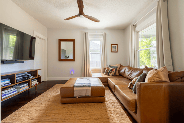Bright and inviting living room with modern decor, large windows, and ample natural light for relaxation.